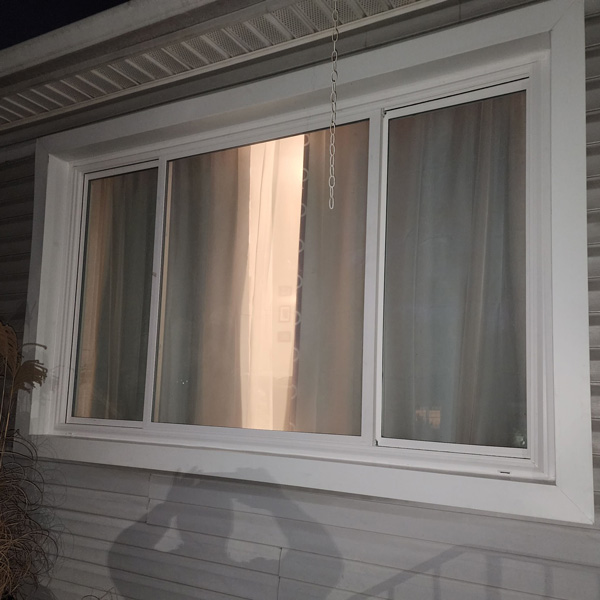 White color frame slider window of a house in Mechanicsburg, PA