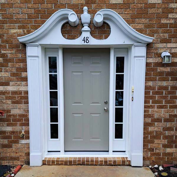 Exterior White Colour entry door with glass block transom and sidelights in brick-style wall in Pennsylvania