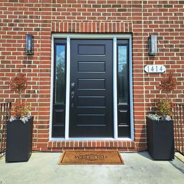 Black exterior door with glass block transom welcoming mat in Pennsylvania Home