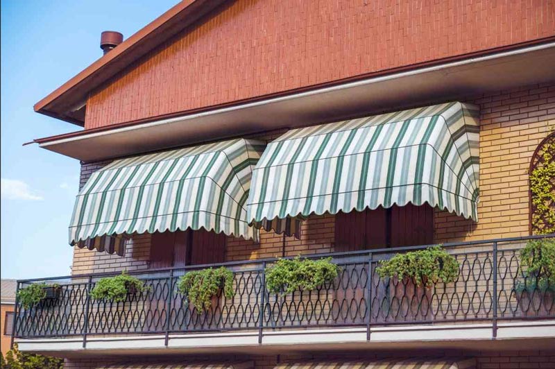 Balcony with awnings and a railing in Mechanicsburg, PA, featuring awning windows