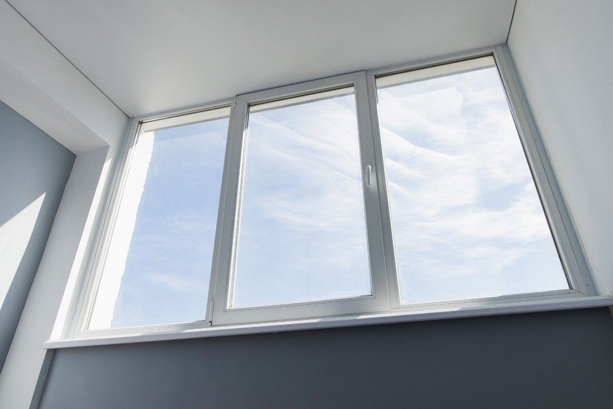 Slider window of a house in Mechanicsburg, PA, with a car parked outside 
