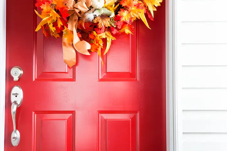 Red wooden front door on a home in PA or DM