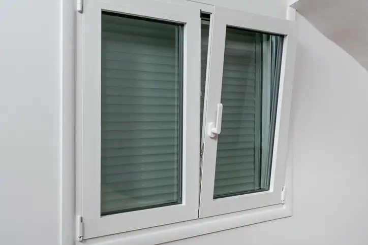Slightly opened double tilt casement window installed on a home in PA or MD